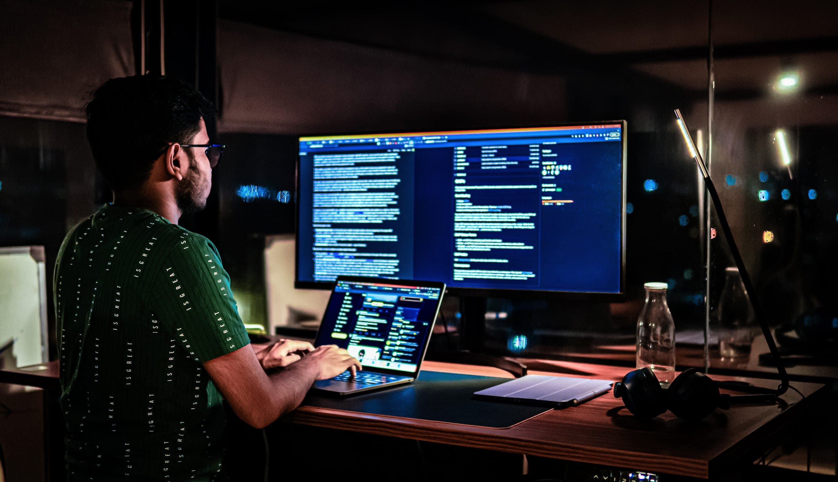 Sitesh working at a desk with multiple screens